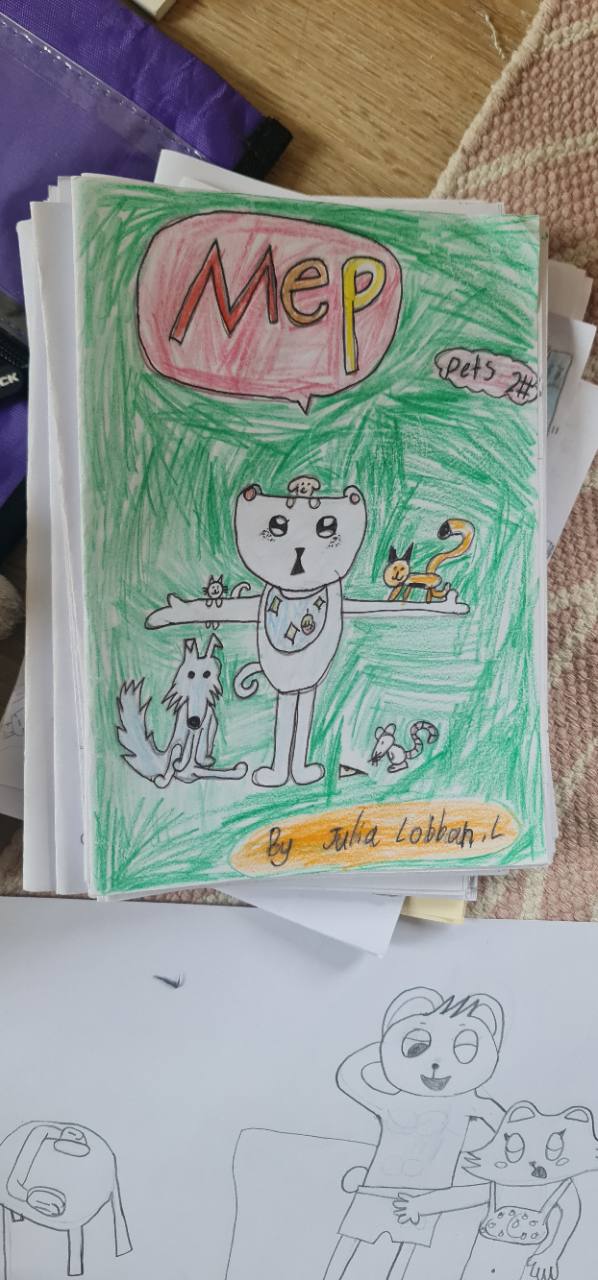 Julia’s real Mep book: a hand-drawn green cover with animal characters and a pink title bubble.